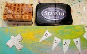 Paint the bird white. Use a permanent inkpad like StazOn and a set of letter stamps and stamp HOME on the flags. You can also cut letters from magazines and glue down.